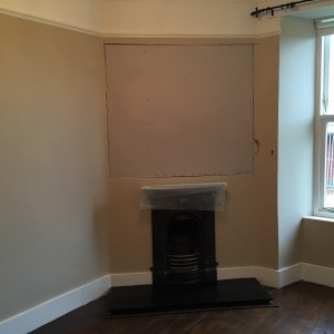 Area above fireplace showing plasterboard